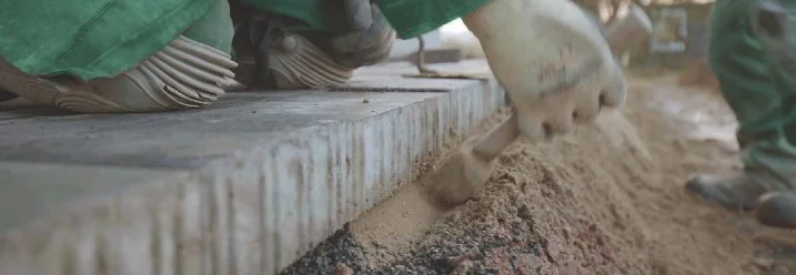 Person ebnet Sand mit Kelle